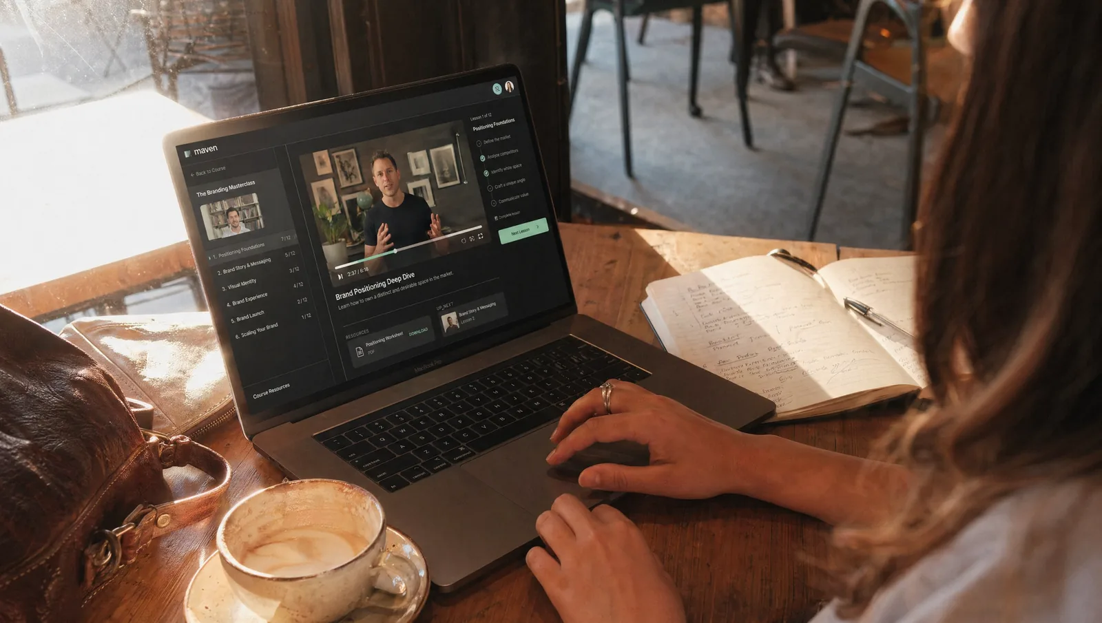 MacBook Pro with LMS platform in a café at golden hour