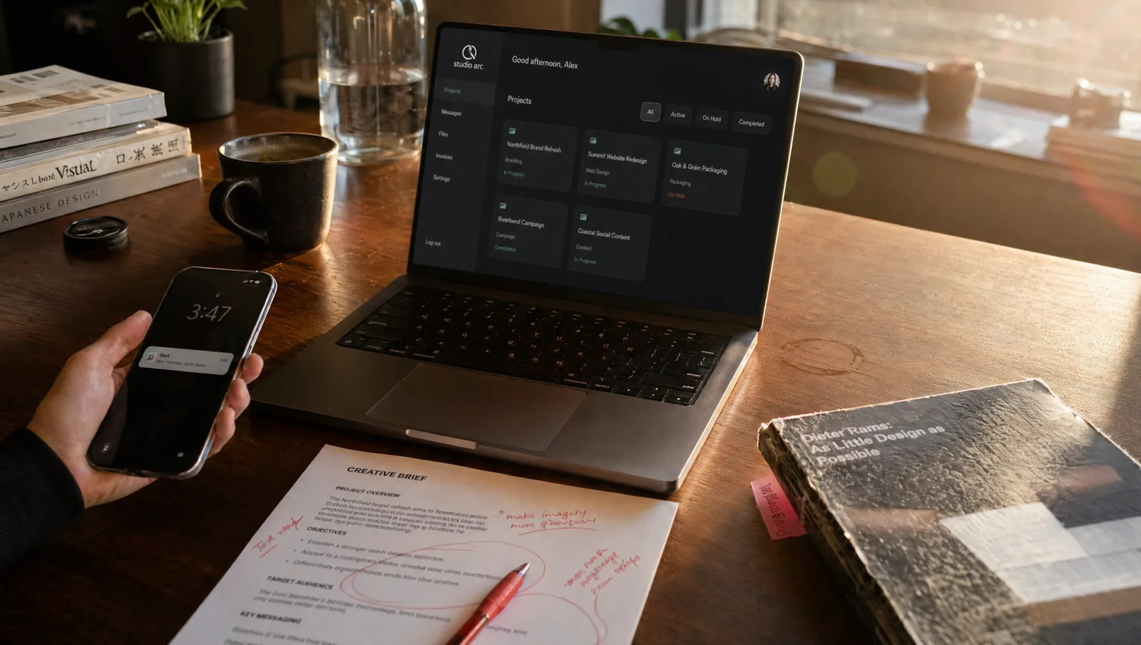MacBook with white-label client portal in a creative studio